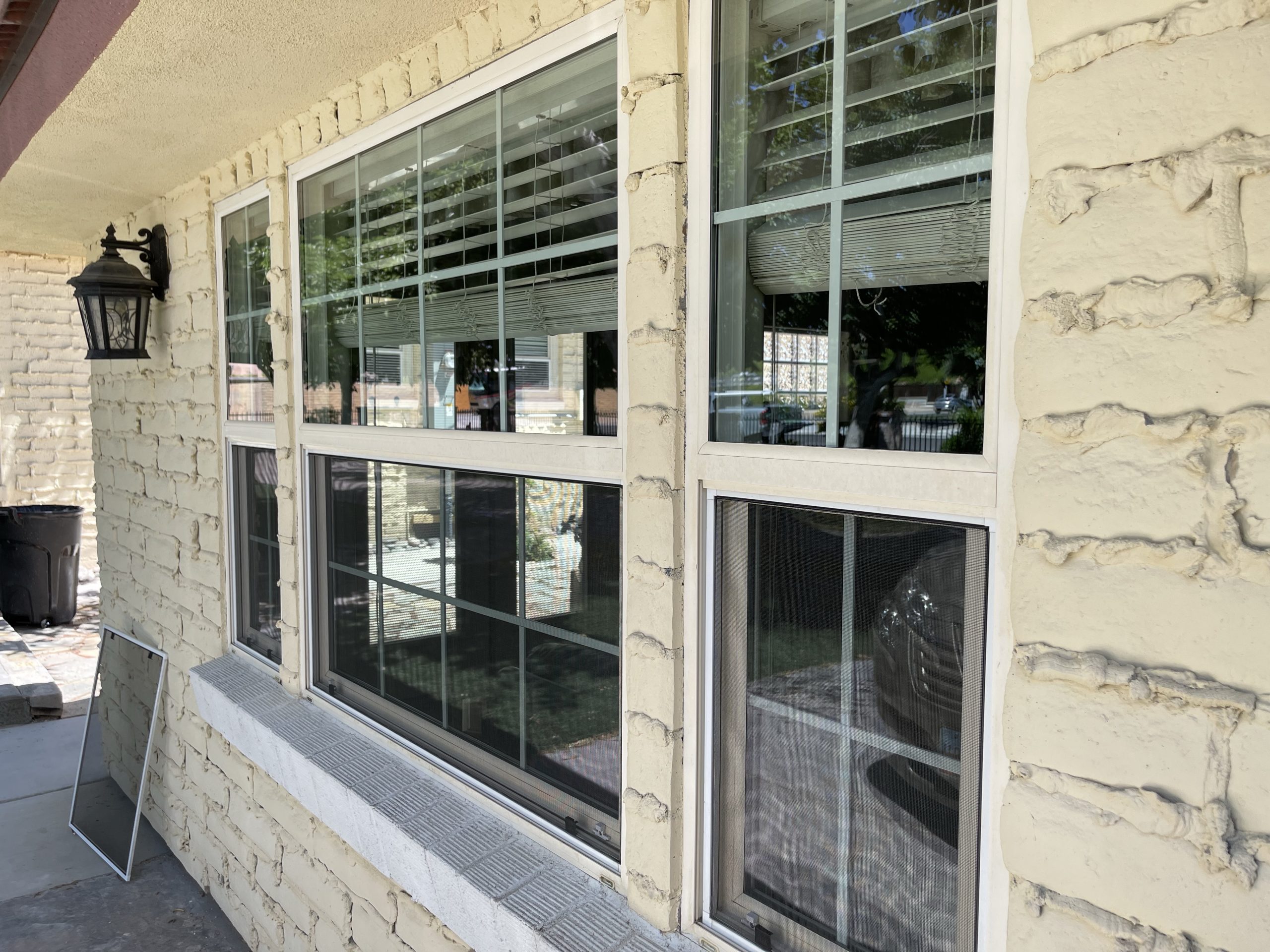 Freshly installed custom window screens on a Las Vegas home, measured and installed to fit the window openings cleanly