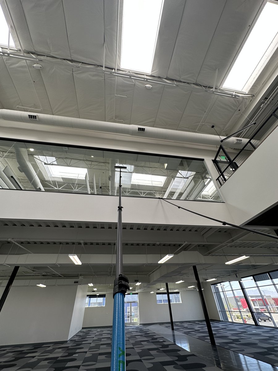 Water-fed pole reaching high atrium glass on a Las Vegas commercial property