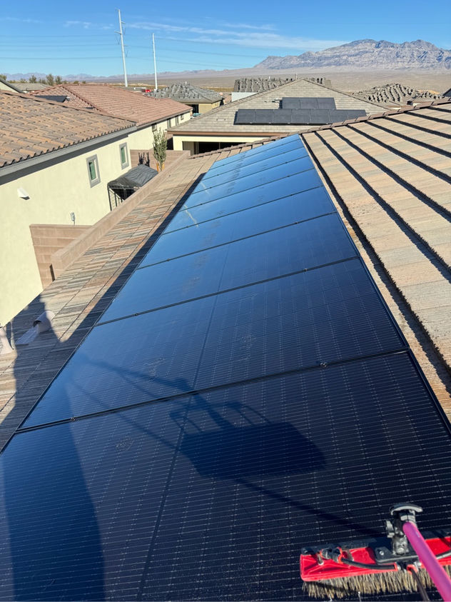 Same residential solar panels after professional cleaning — glossy and reflective with Red Rock Canyon in background